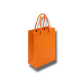 Bolsa de regalo mini naranja de PartyStore con asas de cuerda trenzada, ideal para detalles y obsequios pequeños.