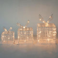 Cajas de regalo luminosas PartyStore con estructura de alambre plateado y luces LED cálidas para decoración navideña